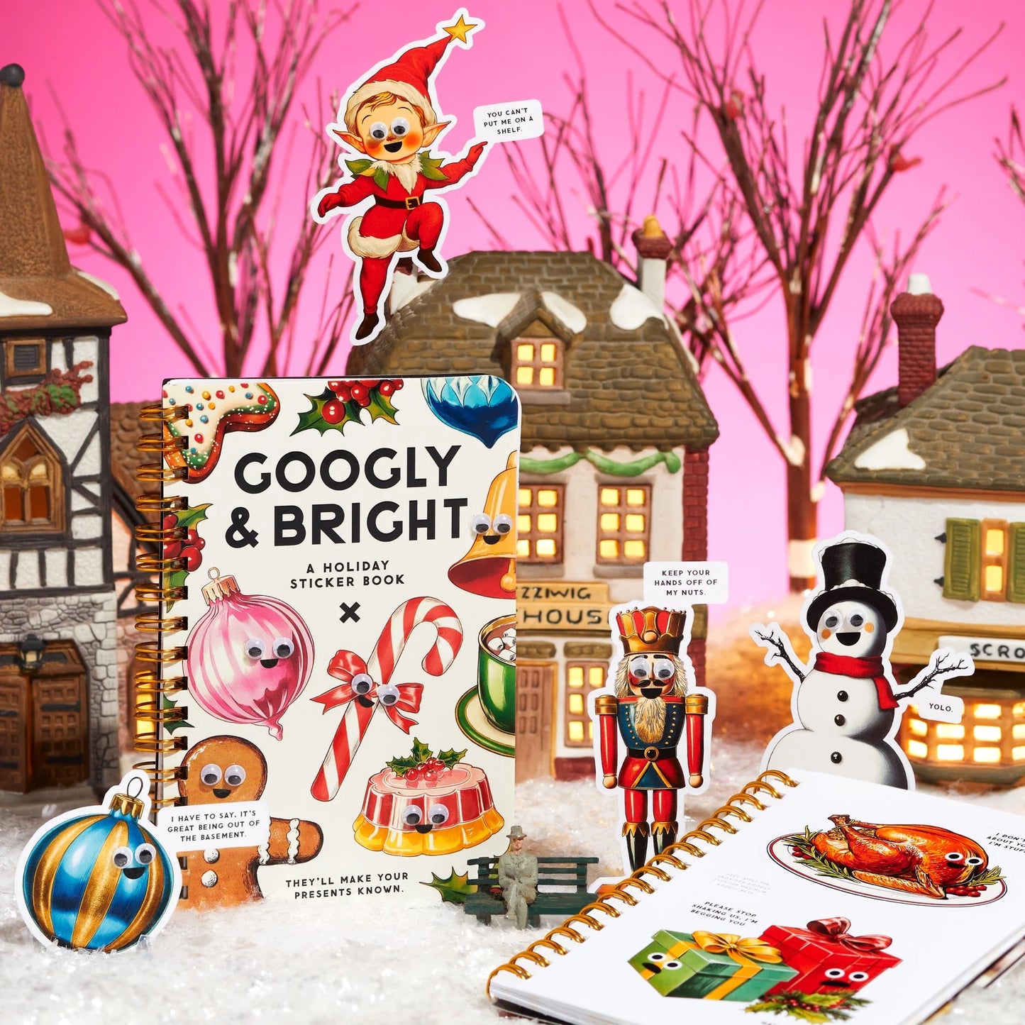 Holiday-themed sticker book with festive illustrations on a pink background with Christmas village scene.