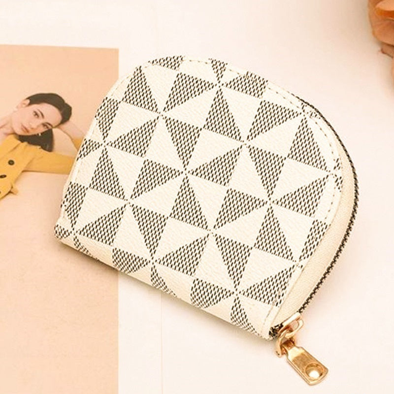 Ivory patterned pouch with gold zipper on a light background