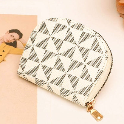 Ivory patterned pouch with gold zipper on a light background