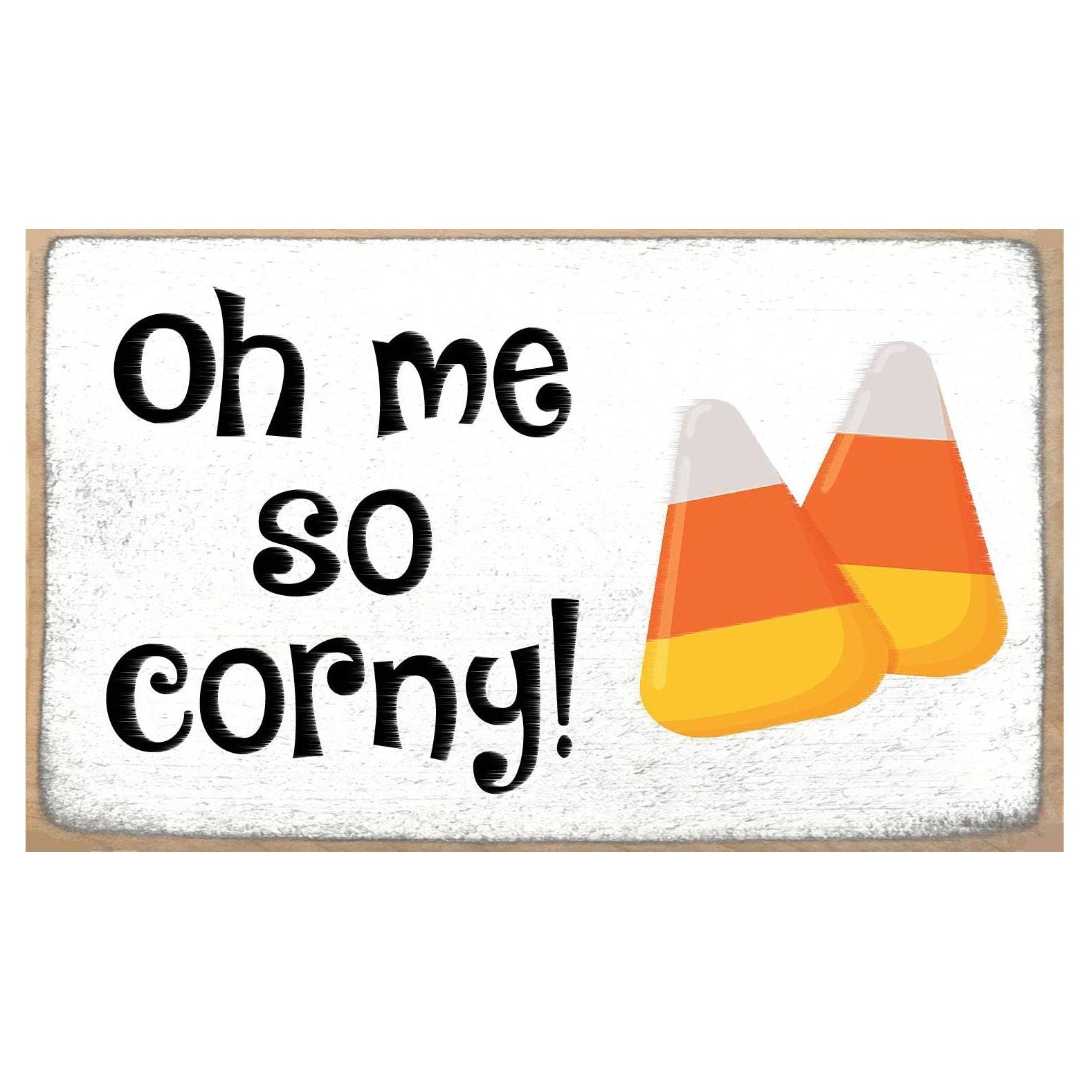 A rectangular decorative sign with a white textured background and a light wood border. The sign reads 'Oh me so corny!' in black lettering and features two illustrated candy corn candies on the right side.