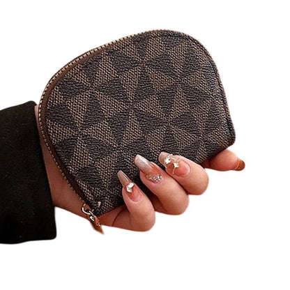 Brown patterned pouch held by a hand on a white background