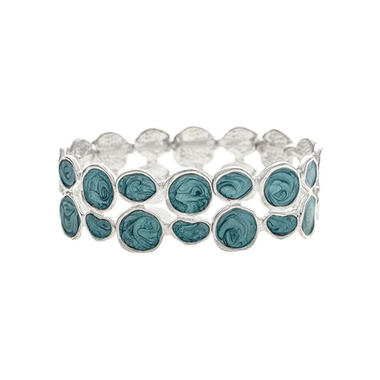 A silver stretch band bracelet featuring a row of oval-cut teal blue-green gemstones, set against a plain white background.