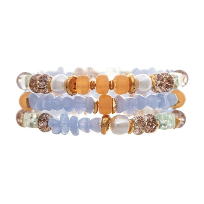 Three stacked beaded bracelets featuring light blue, peach, white, and brown textured beads on a solid white background.