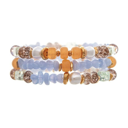 Three stacked beaded bracelets featuring light blue, peach, white, and brown textured beads on a solid white background.