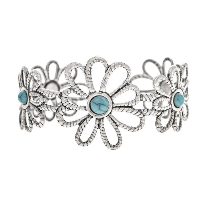 A silver-toned Southwestern-style cuff bracelet featuring a central daisy flower motif with three smaller matching flowers on each side, accented by round light blue turquoise stones.