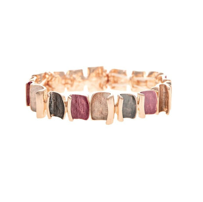 A rose gold band bracelet featuring a row of rectangular, bezel-set natural gemstones in pink, gray, and beige tones, shown against a plain white background.