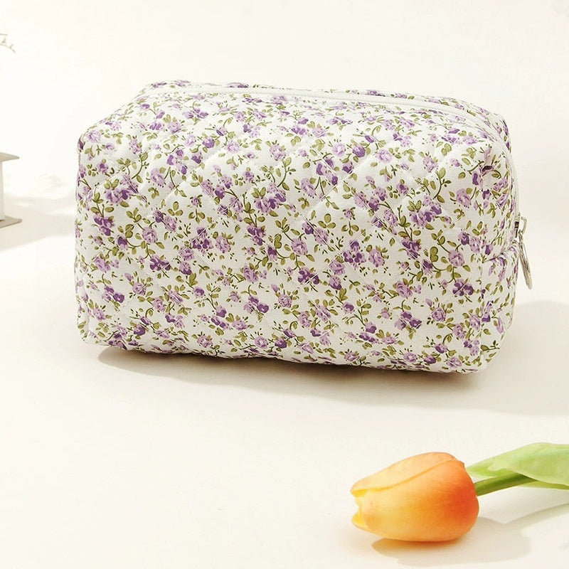 Floral-patterned toiletry bag with a tulip on a light background