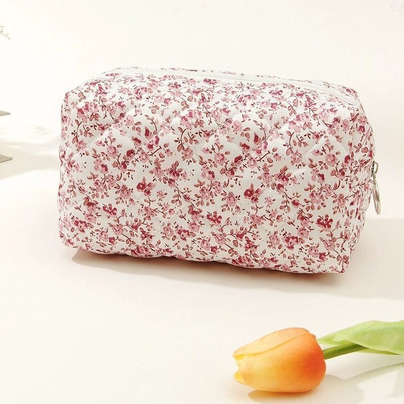 Floral-patterned toiletry bag with a tulip on a light background